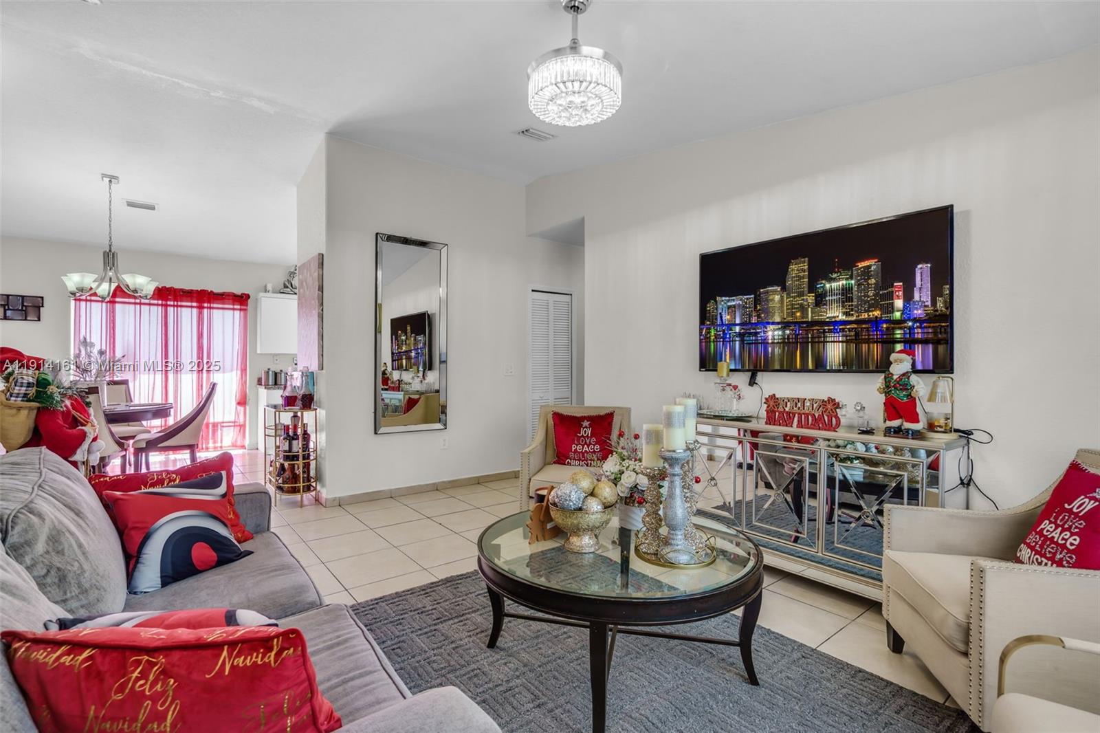 7271 Northwest 174th Terrace, Unit 202 Hialeah, FL 33015 - Photo 5 of 22 a living room with furniture and a wooden floor