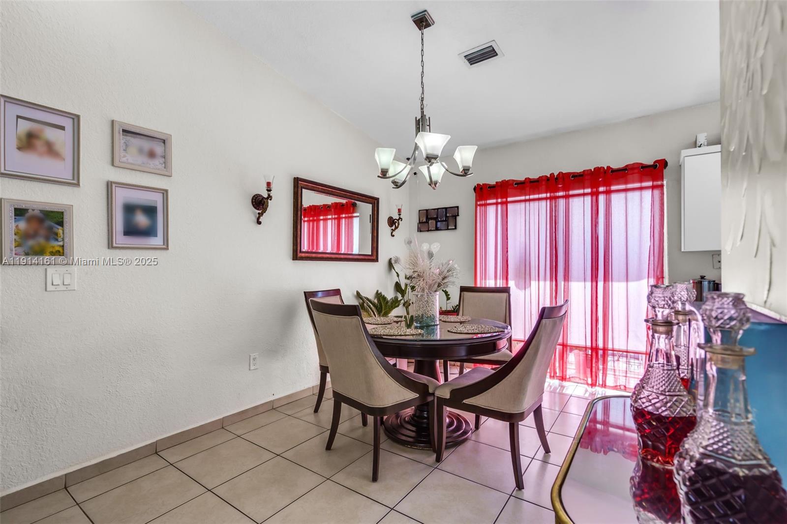 7271 Northwest 174th Terrace, Unit 202 Hialeah, FL 33015 - Photo 6 of 22 a view of a dining room with furniture and chandelier
