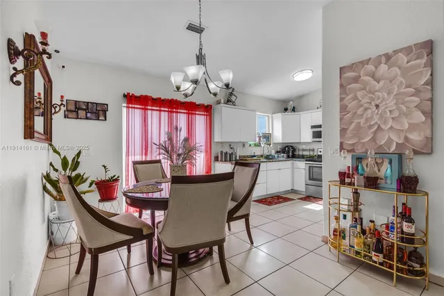 a dining room with furniture and a chandelier