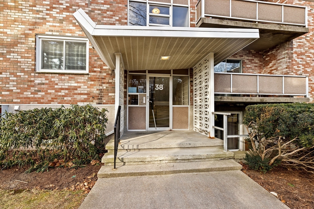 38 Jacqueline Road, Unit B Waltham, MA 02452 - Photo 1 of 21 a view of a house with a large window and plants