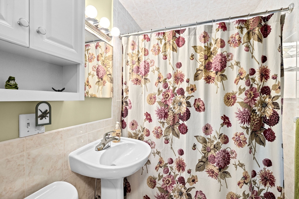 38 Jacqueline Road, Unit B Waltham, MA 02452 - Photo 13 of 21 a bathroom with a sink and a mirror