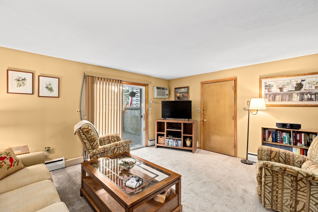 38 Jacqueline Road, Unit B Waltham, MA 02452 - Photo 14 of 21 a living room with furniture and a flat screen tv