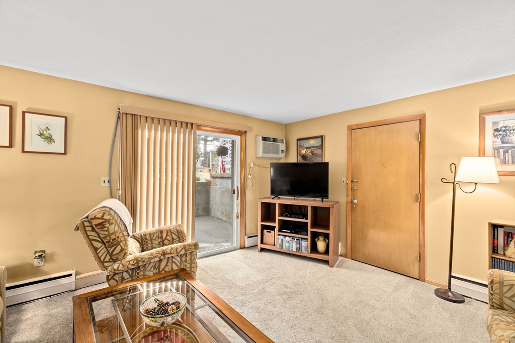 38 Jacqueline Road, Unit B Waltham, MA 02452 - Photo 15 of 21 a living room with furniture and a flat screen tv