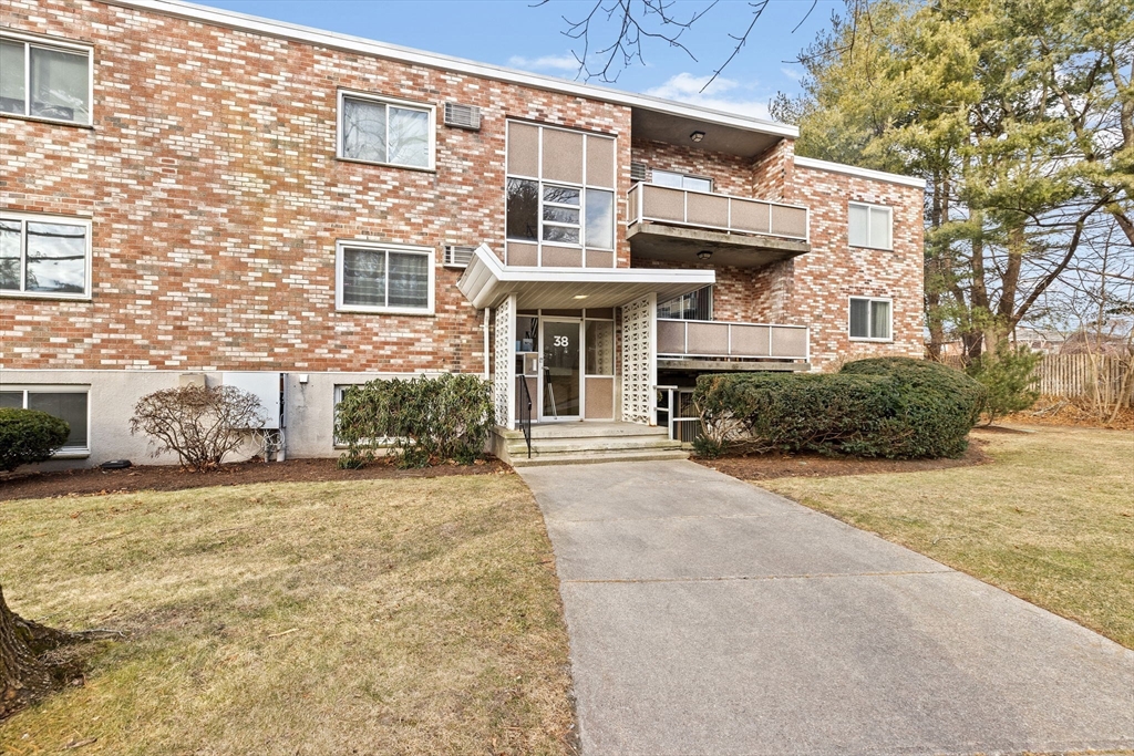38 Jacqueline Road, Unit B Waltham, MA 02452 - Photo 2 of 21 front view of a house with a yard