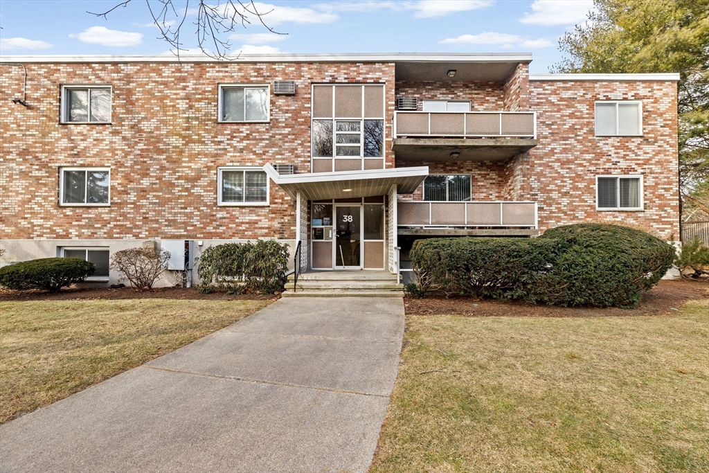 38 Jacqueline Road, Unit B Waltham, MA 02452 - Photo 3 of 21 front view of a house with a yard