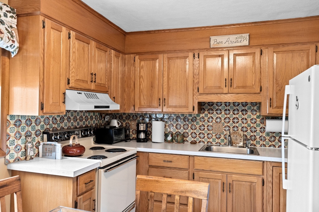 38 Jacqueline Road, Unit B Waltham, MA 02452 - Photo 4 of 21 a kitchen with a sink stove and cabinets