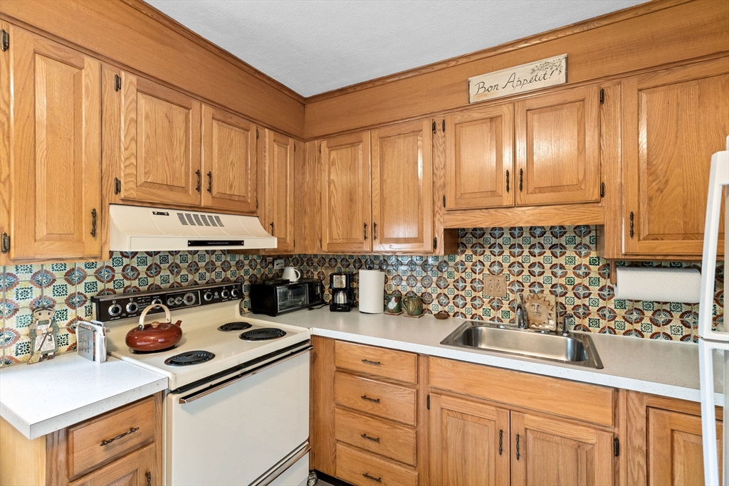 38 Jacqueline Road, Unit B Waltham, MA 02452 - Photo 5 of 21 a kitchen with a sink cabinets and appliances