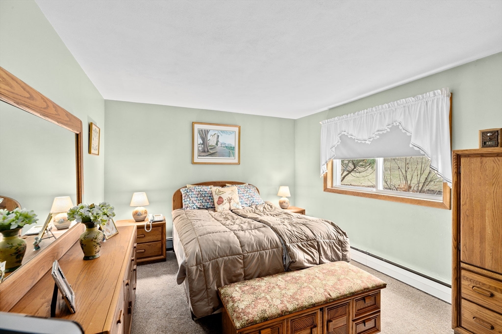 38 Jacqueline Road, Unit B Waltham, MA 02452 - Photo 9 of 21 a bedroom with a bed and a painting on the wall