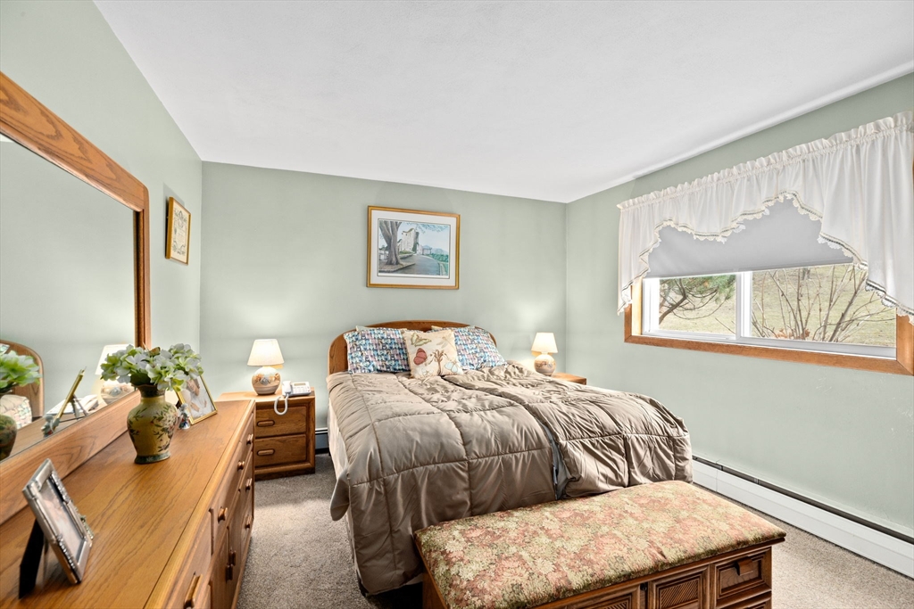 38 Jacqueline Road, Unit B Waltham, MA 02452 - Photo 10 of 21 a bedroom with a bed flowerpot and window