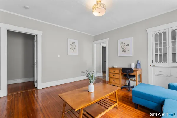 a living room with furniture a rug and a window