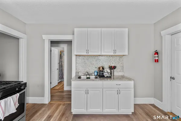 a kitchen with stainless steel appliances granite countertop a sink stove and cabinets