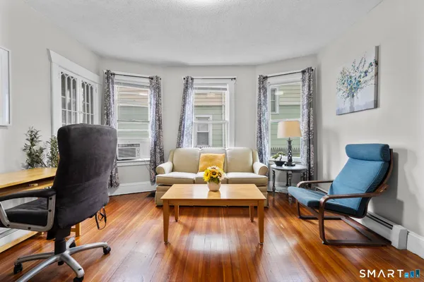 a living room with furniture and wooden floor