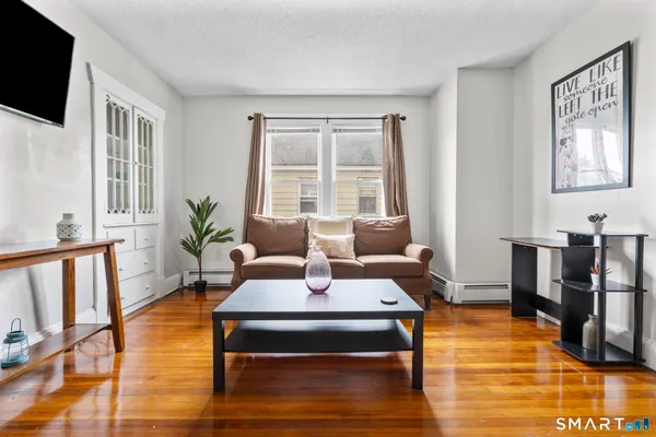 a living room with furniture fireplace and flat screen tv