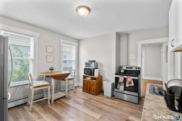 a living room with furniture a wooden floor and a window