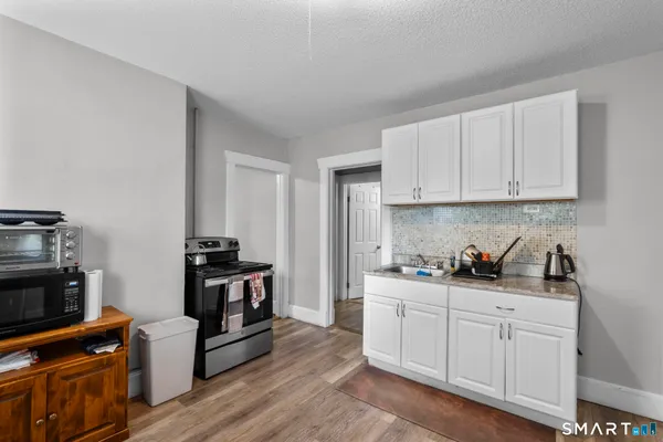 a kitchen with sink a stove and cabinets