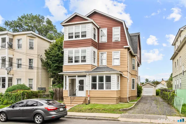 a front view of a residential apartment building with a yard