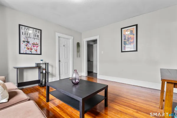 a room with table chairs and wooden floor