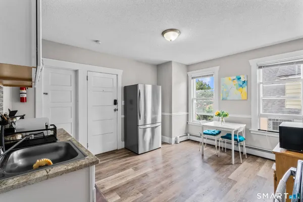 a kitchen that has a refrigerator and a sink in it