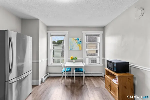 a dining room with furniture and a window