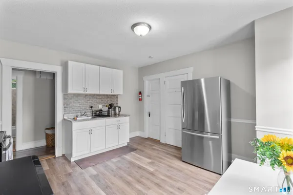 a kitchen with stainless steel appliances a refrigerator and a stove top oven