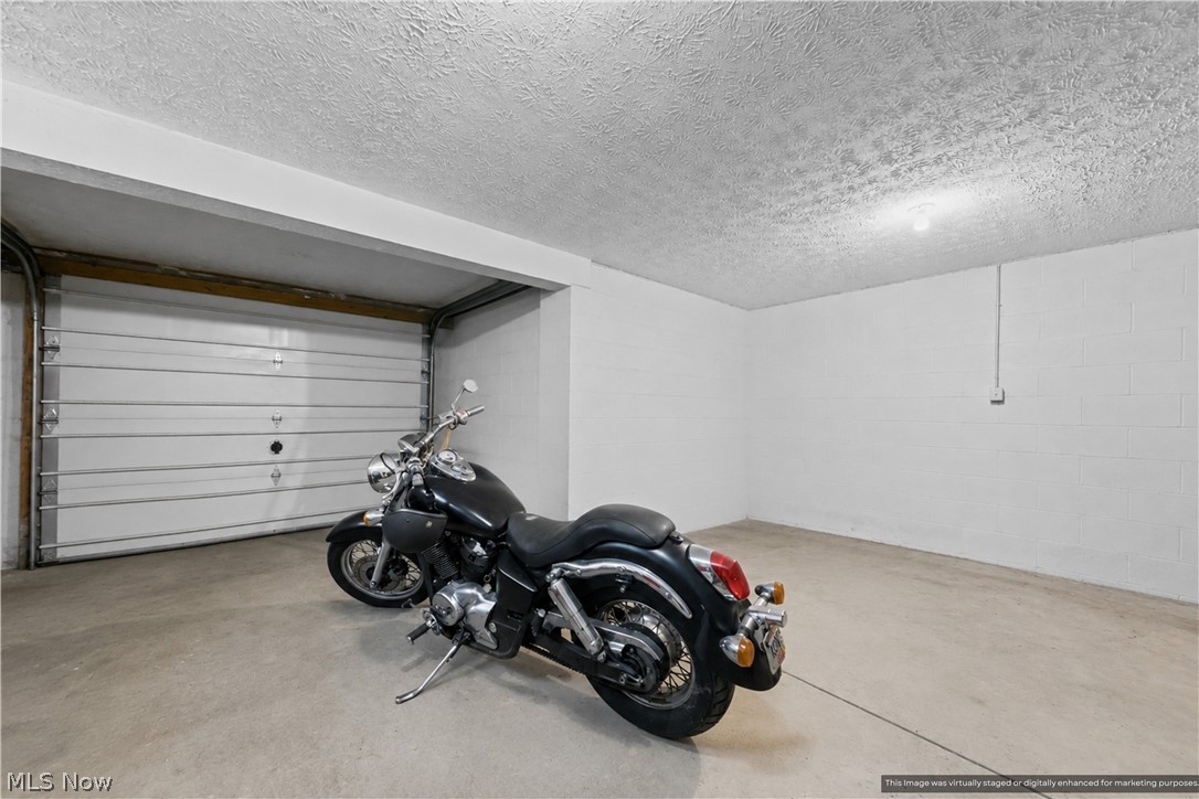 1835 Lynn Road Kent, OH 44240 - Photo 45 of 48 Spacious garage featuring a concrete floor, white walls, and a white overhead garage door
