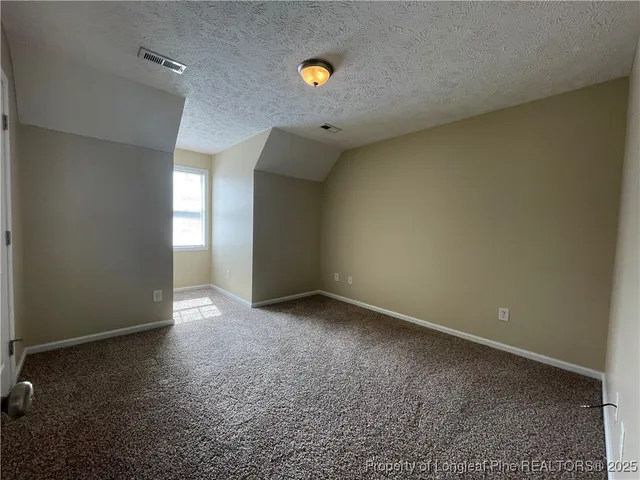 a view of an empty room and closet area
