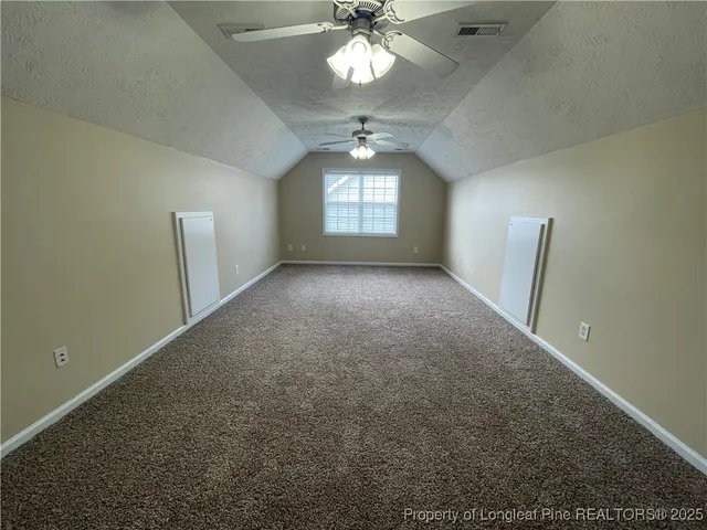 a view of a livingroom with a ceiling fan and window