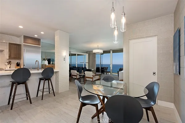 a view of a dining room with furniture and a chandelier