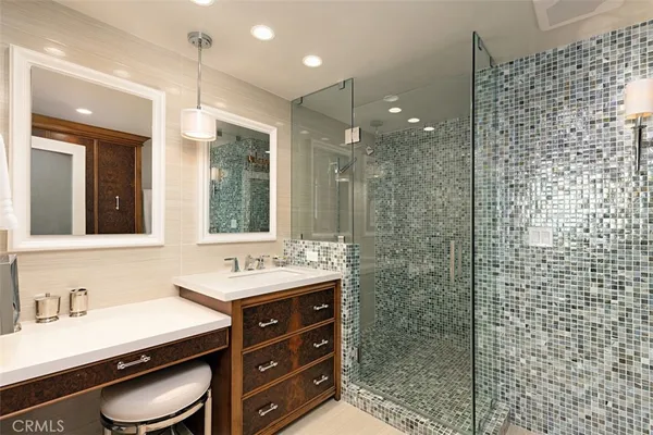 a bathroom with a sink double vanity and a shower