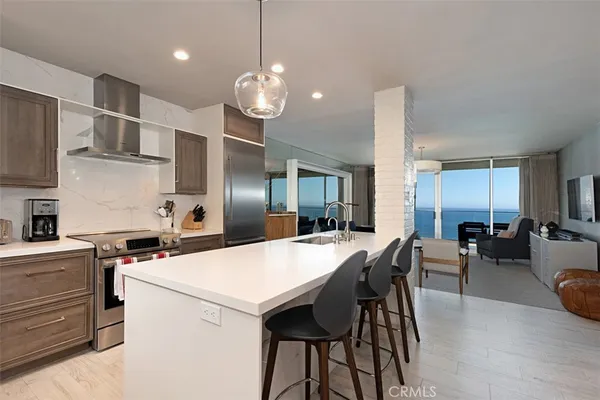 a large kitchen with a table and chairs