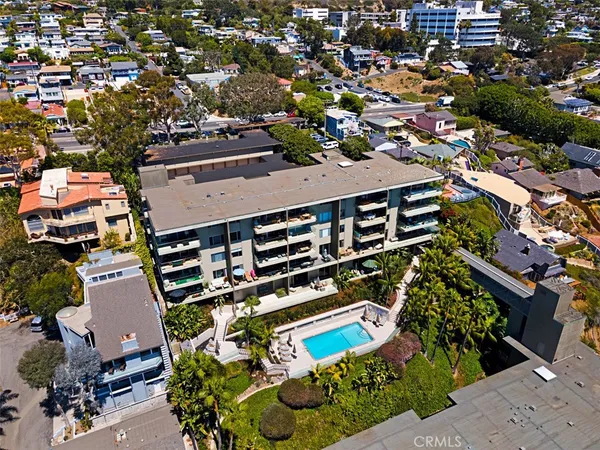 an aerial view of a house with a swimming pool yard and outdoor seating
