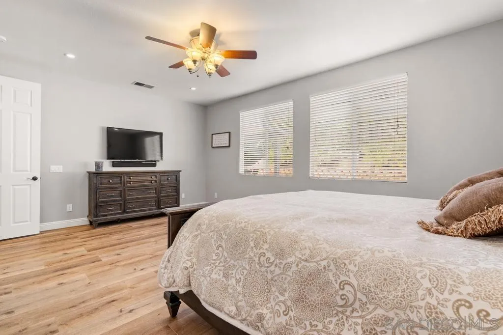 1253 Sunset Heights Road Escondido, CA 92026 - Photo 13 of 30 a bedroom with a bed a dresser and a flat screen tv