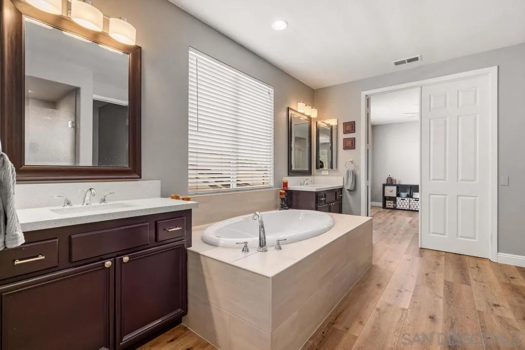 1253 Sunset Heights Road Escondido, CA 92026 - Photo 15 of 30 a bathroom with a tub sink and mirror