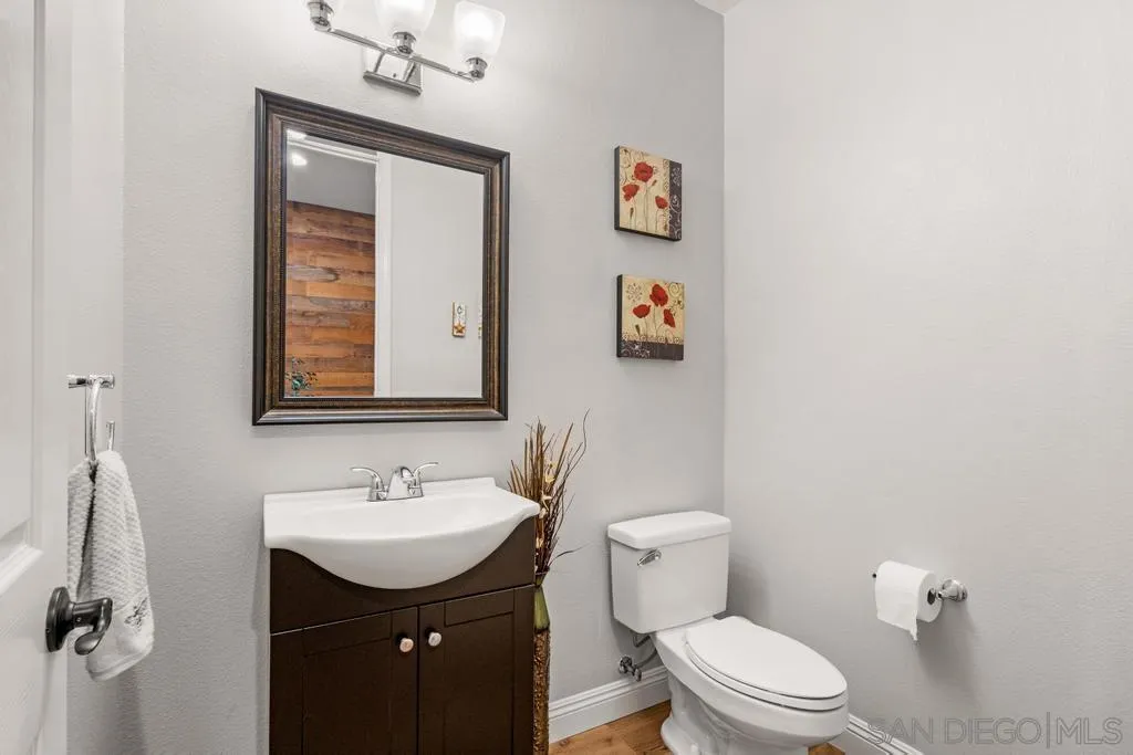 1253 Sunset Heights Road Escondido, CA 92026 - Photo 21 of 30 a bathroom with a toilet sink and mirror