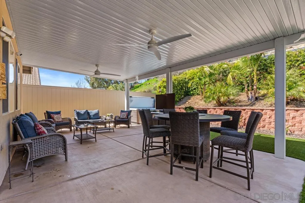 1253 Sunset Heights Road Escondido, CA 92026 - Photo 23 of 30 a view of a patio with a table and chairs under an umbrella with a couch
