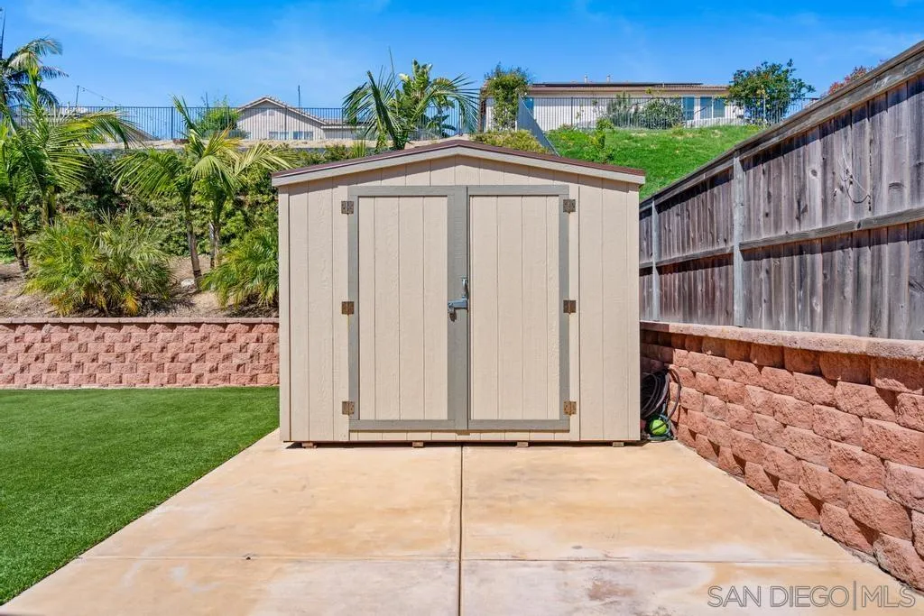 1253 Sunset Heights Road Escondido, CA 92026 - Photo 28 of 30 a view of a house with wooden fence next to a yard