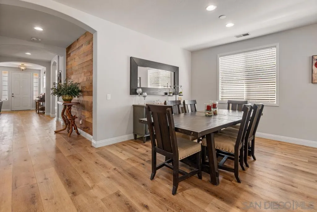 1253 Sunset Heights Road Escondido, CA 92026 - Photo 7 of 30 a view of a dining room with furniture and wooden floor
