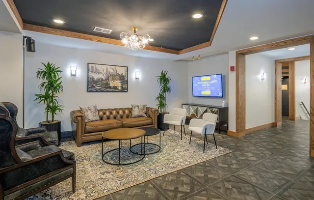 a living room with furniture and a chandelier