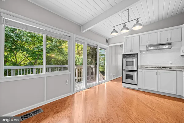 a view of a kitchen with furniture and an empty room