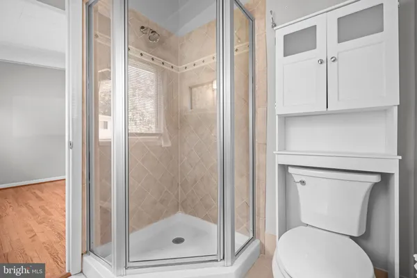 a bathroom with a toilet and a shower