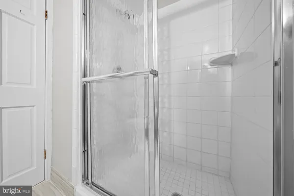 a bathroom with a glass shower door