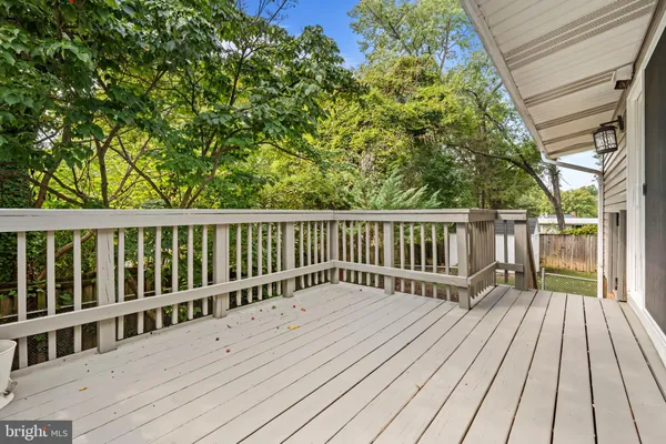 a balcony with wooden floor and fence