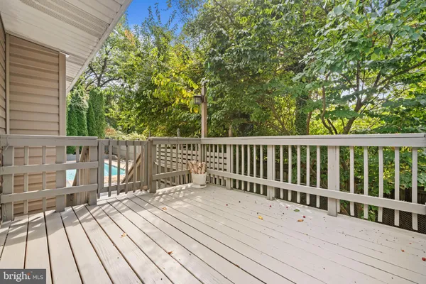 a balcony with wooden floor and fence