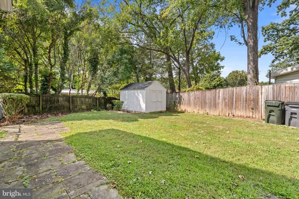 a backyard of a house with a garden and tree