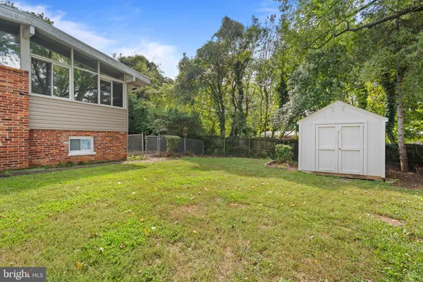 a view of a backyard with a garden and entertaining space