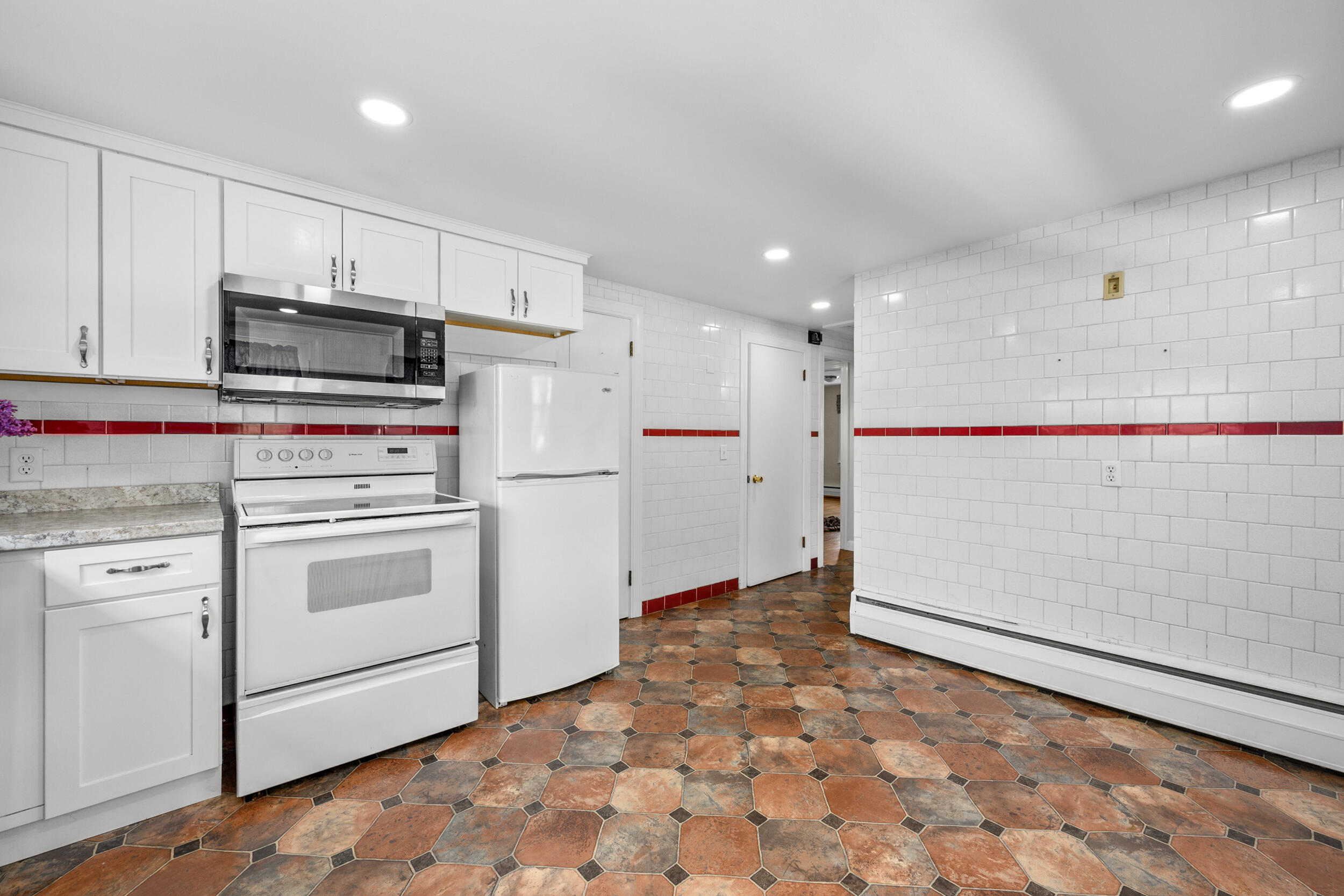 129 Belmont Road West Harwich, MA 02671 - Photo 16 of 27 a kitchen with white cabinets and white appliances