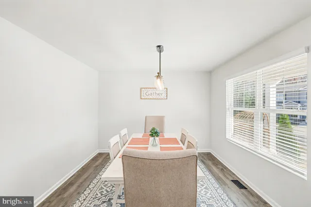 a dining room with table and window
