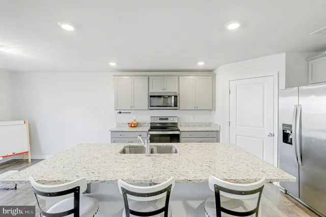 a kitchen with a stove a sink and a refrigerator