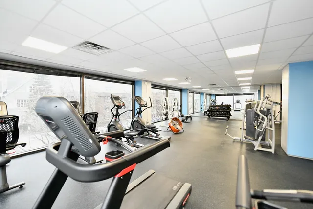 a room with gym equipment and a large window