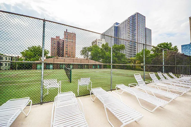 a view of a deck with a chair and floor to ceiling window